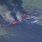 16 dead after military plane carrying weapons explodes mid-air then crashes